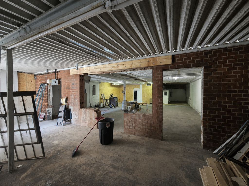 Turned into Restaurant. Cut opening into brick wall for store front doors and windows