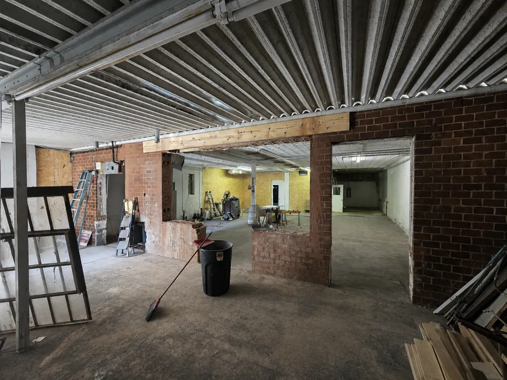 Turned into Restaurant. Cut opening into brick wall for store front doors and windows
